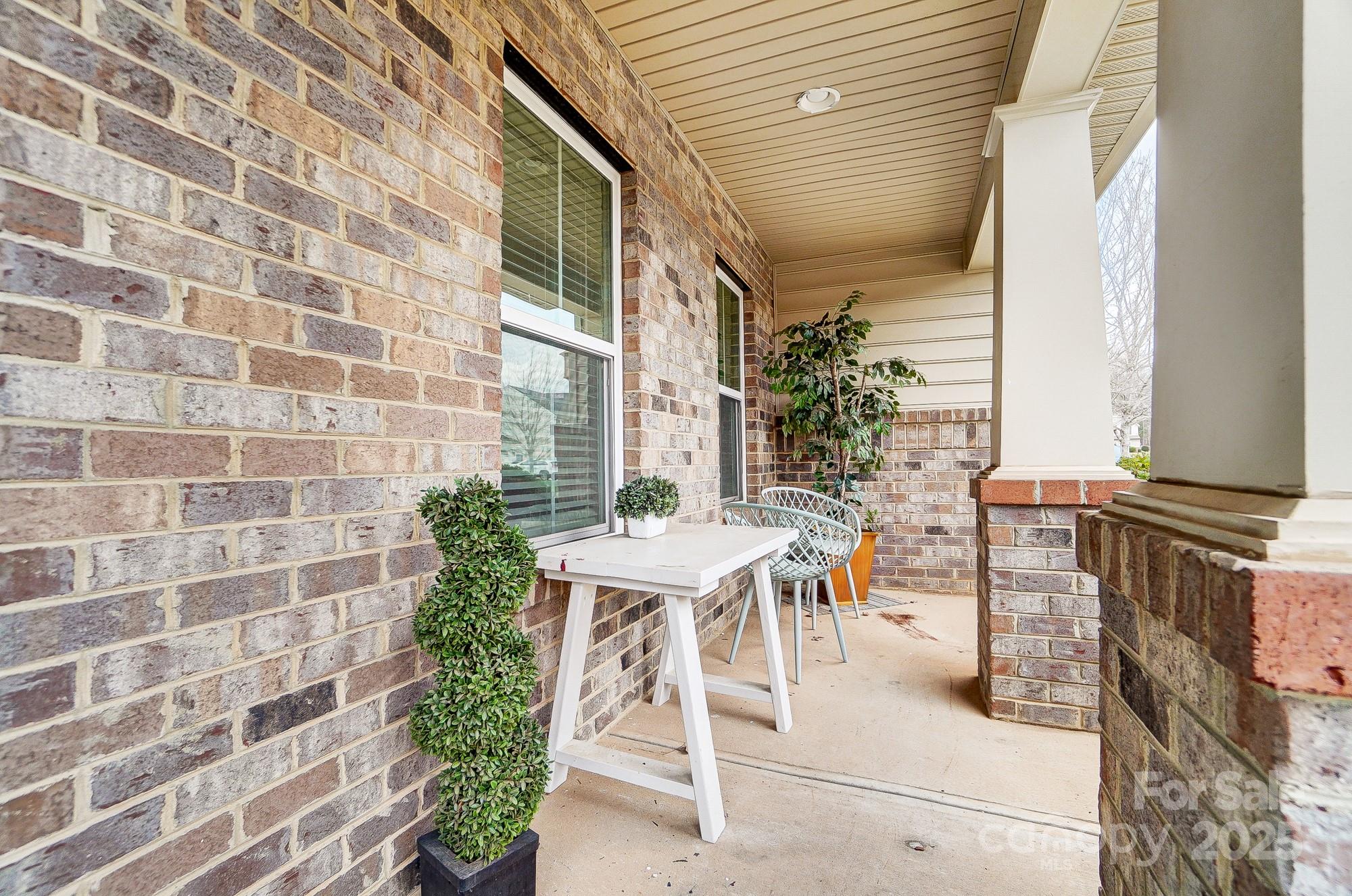 2065 Taney Way Indian Land, SC 29707 - Photo 4 of 43 a view of a patio with a table and chairs and potted plants