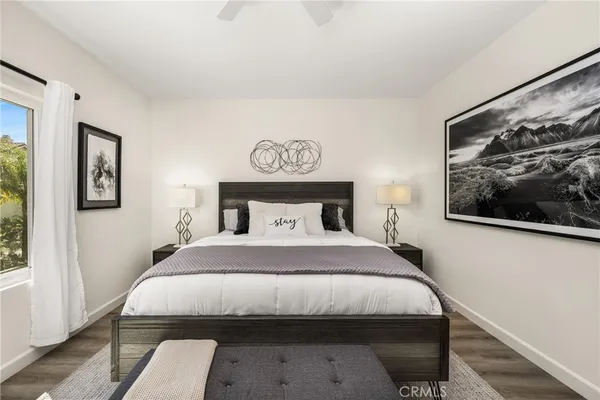 a bedroom with a bed and table chair