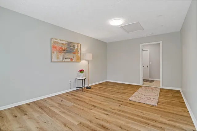 a view of a yard with wooden fence