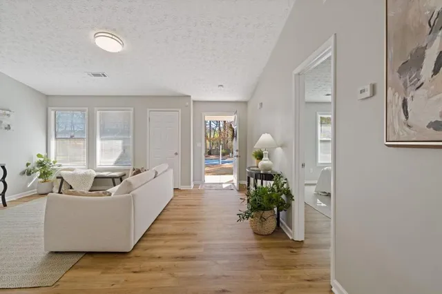 a living room with furniture and a wooden floor