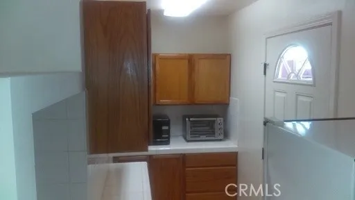a kitchen with a refrigerator and a sink