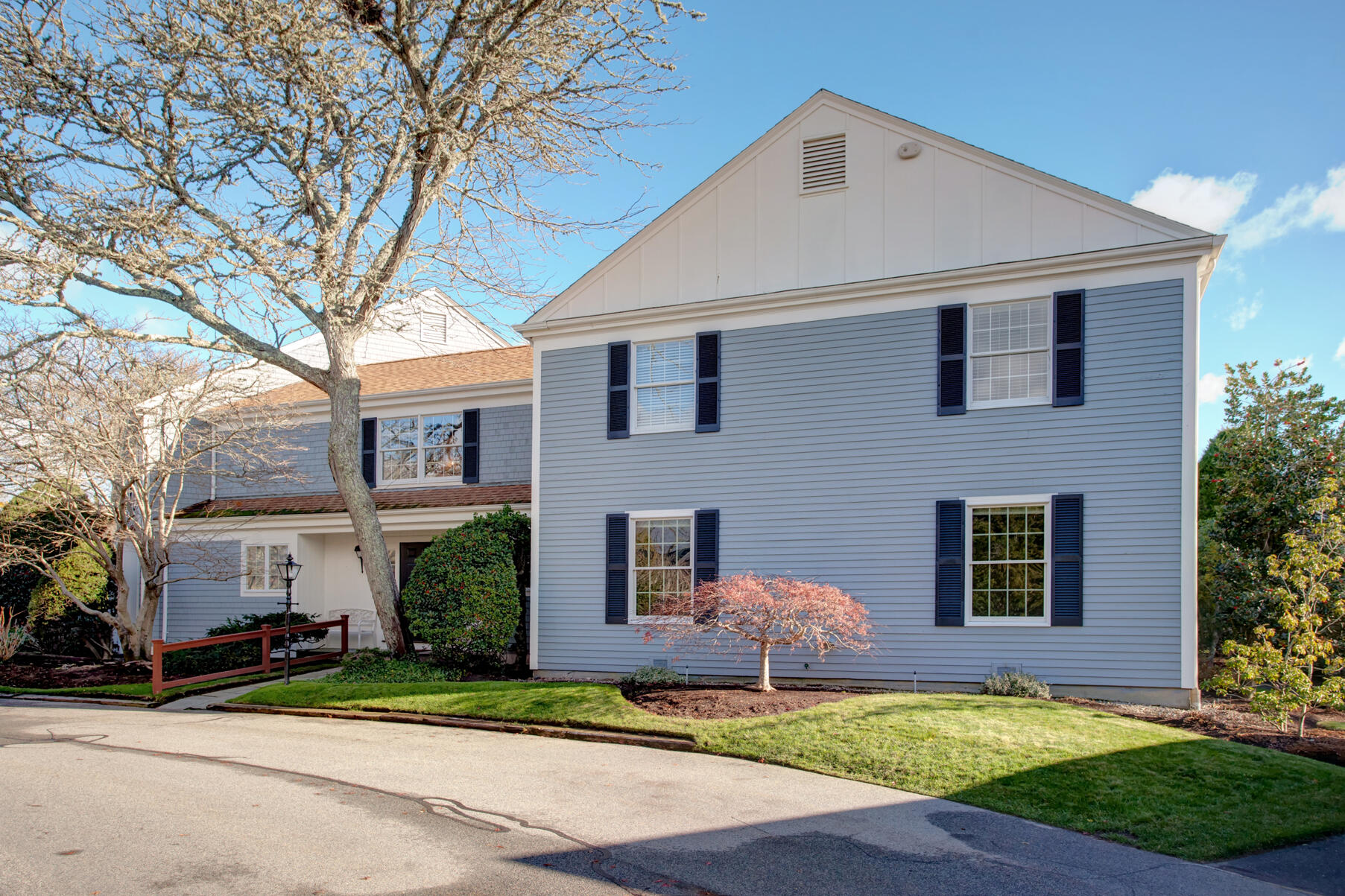 39 Tower Hill Road, Unit 16C Osterville, MA 02655 - Photo 41 of 42 a front view of a house with a yard and garage