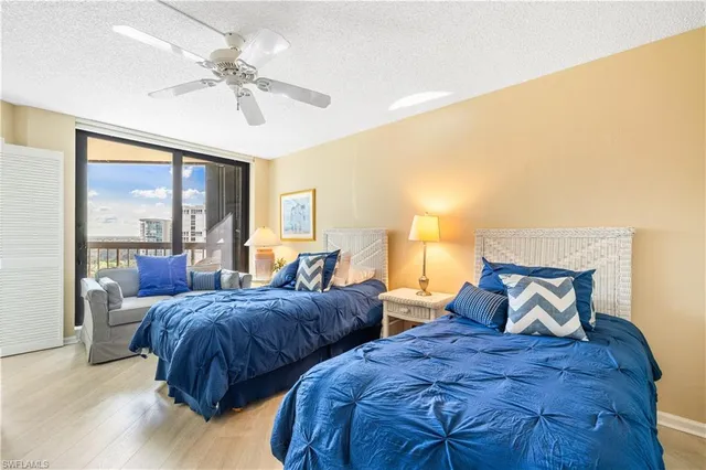 a bedroom with two beds and a large window