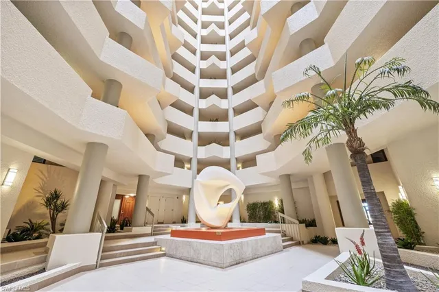 a living room with a large mirror and a chandelier