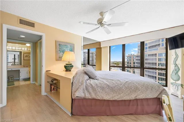 a living room with a bed furniture and a kitchen view