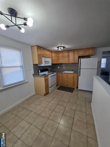 a kitchen with a refrigerator and a stove top oven