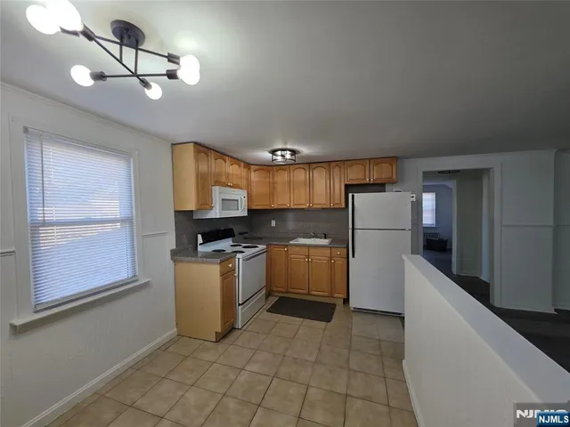 a kitchen with a stove cabinets and a sink