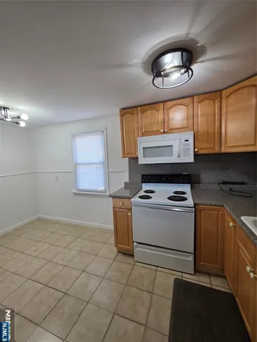 a view of a kitchen with an empty space and a window