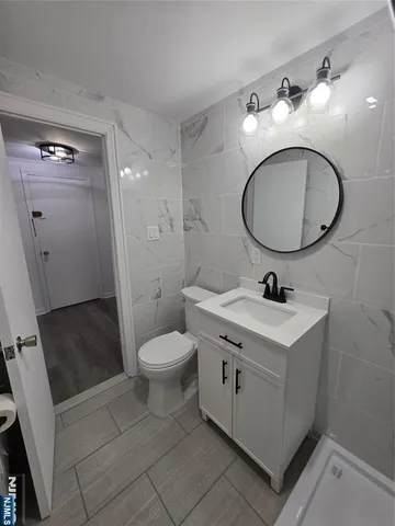 a view of a kitchen with a sink and a refrigerator