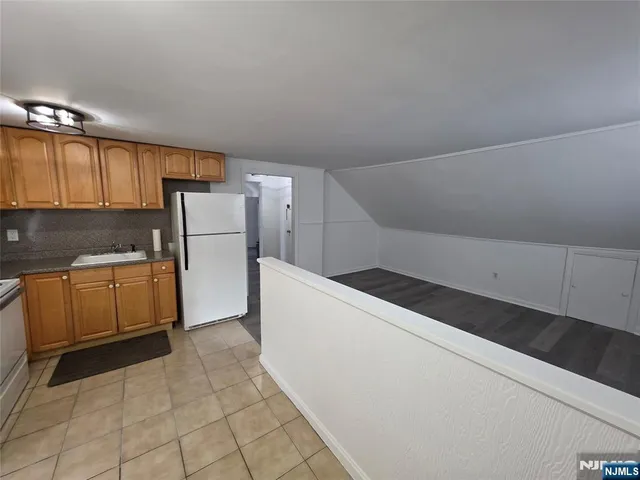 a kitchen with a sink a stove top oven and cabinets