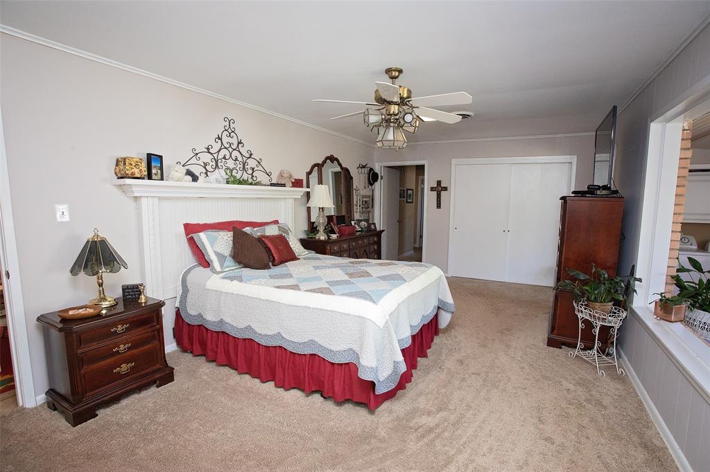914 Fairview Street Graham, TX 76450 - Photo 7 of 17 a bedroom with bed and a chandelier
