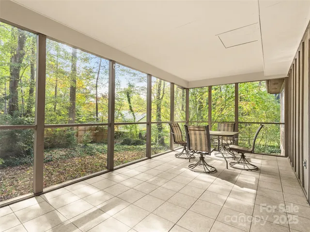 a view of a room and workspace with large windows