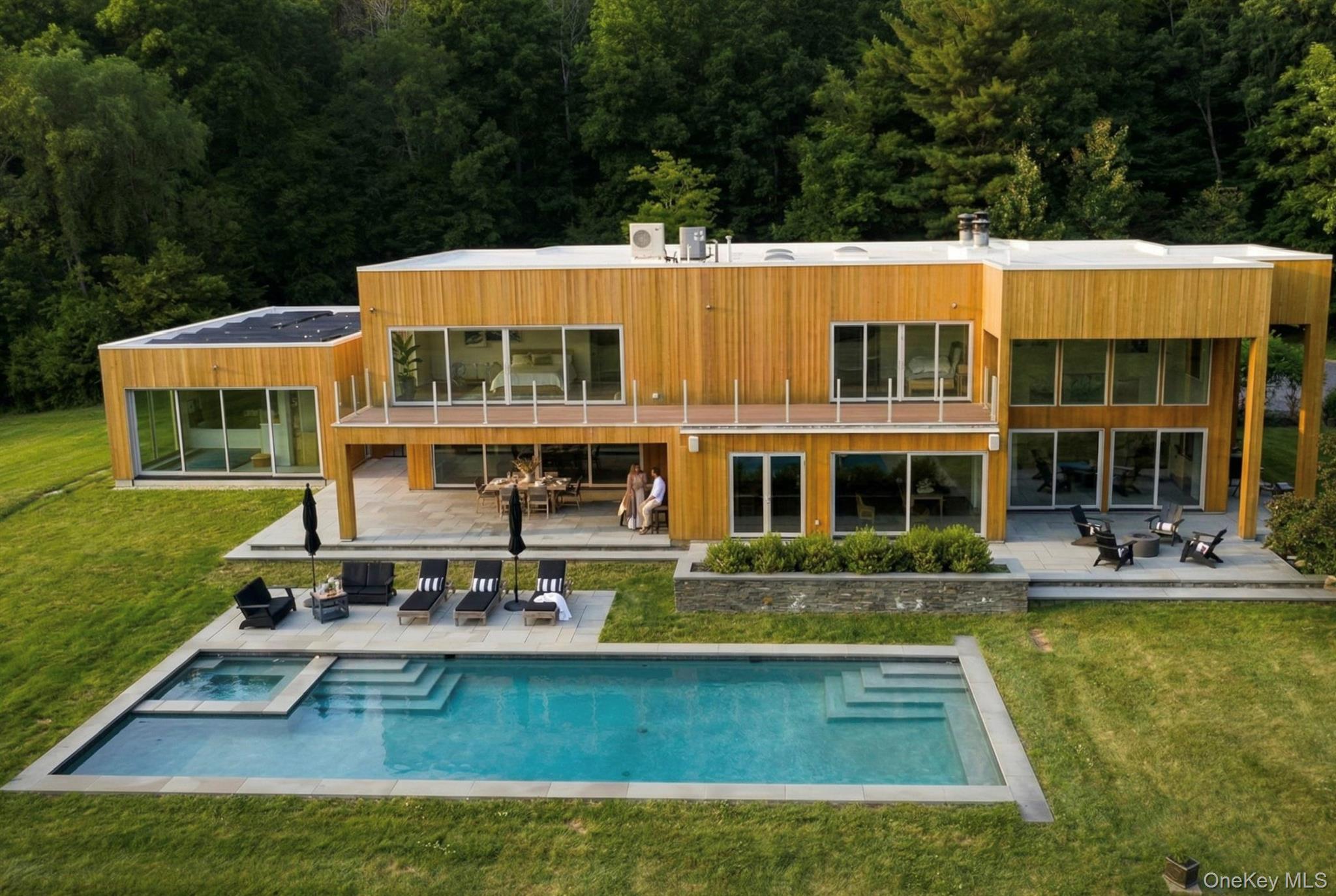 a view of a house with swimming pool and sitting area