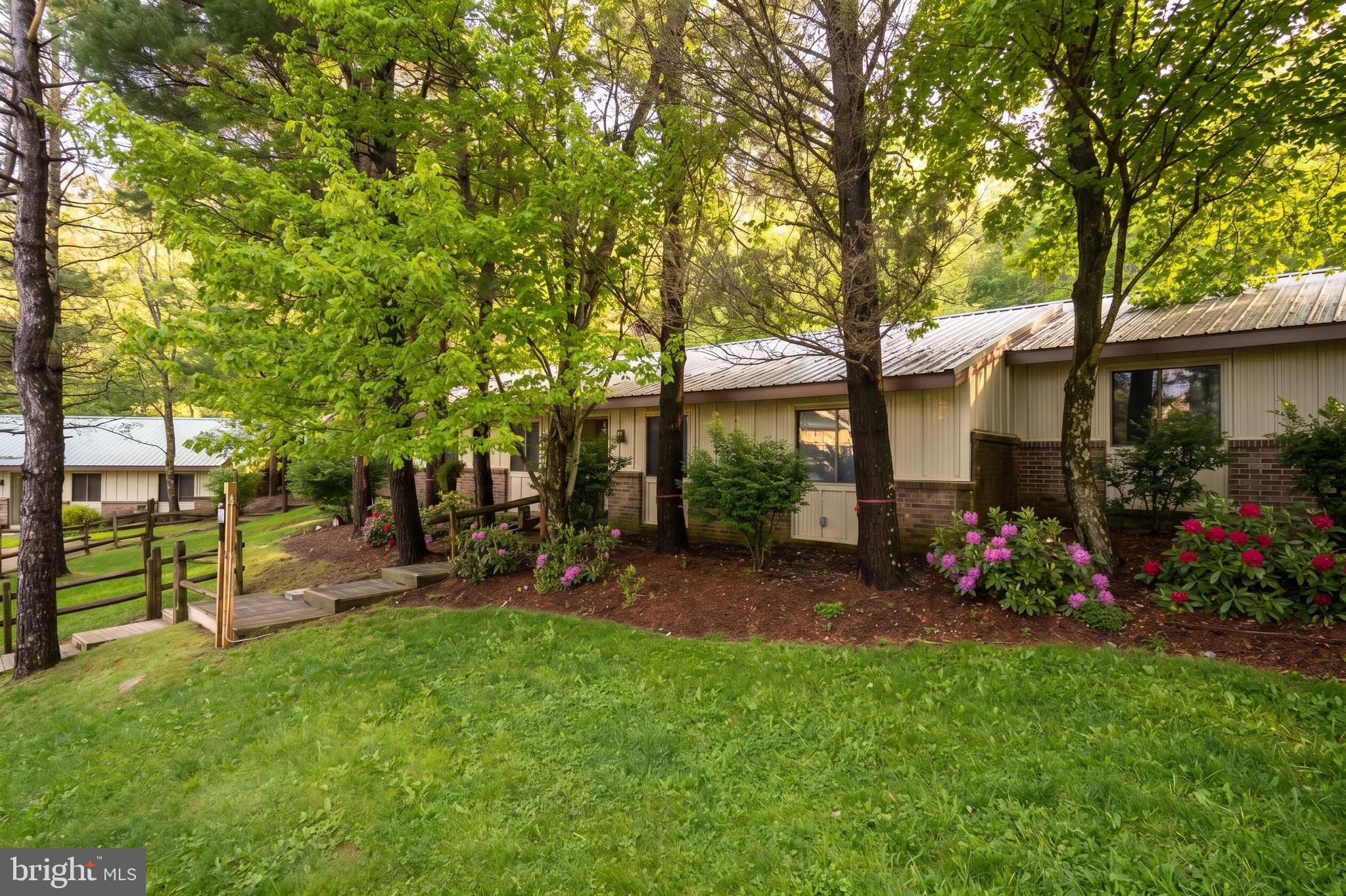 1724 Mosser Road, Unit 11 McHenry, MD 21541 - Photo 22 of 24 a view of a chair and table in backyard of the house