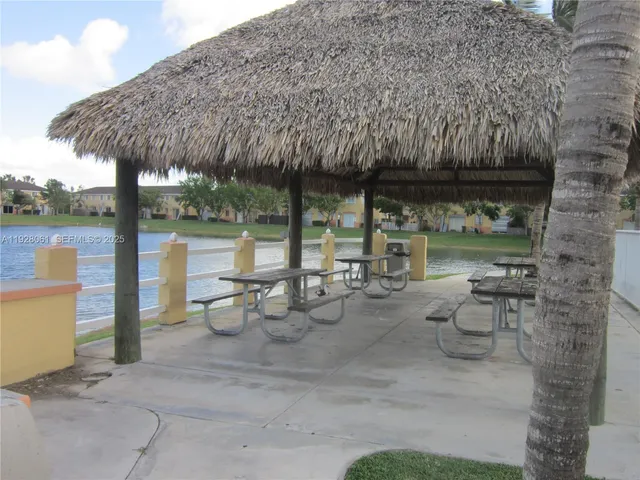a view of a patio with chairs and potted plants