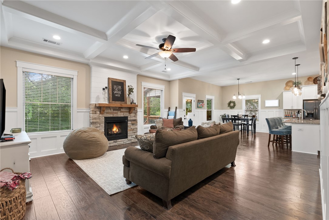 201 Hearthstone Drive Anderson, SC 29621 - Photo 9 of 49 A welcoming living area boasts coffered ceilings and rich hardwood flooring, centered by a cozy fireplace.