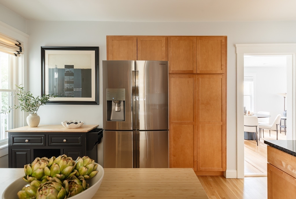 128 Thorndike Street, Unit 128 Arlington, MA 02474 - Photo 4 of 20 a kitchen with a refrigerator and a table