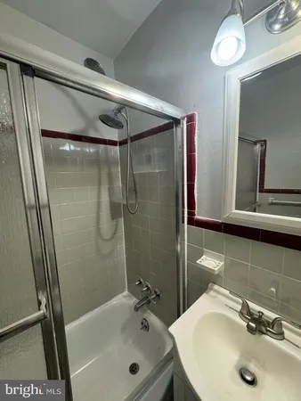 a bathroom with a sink toilet and a mirror