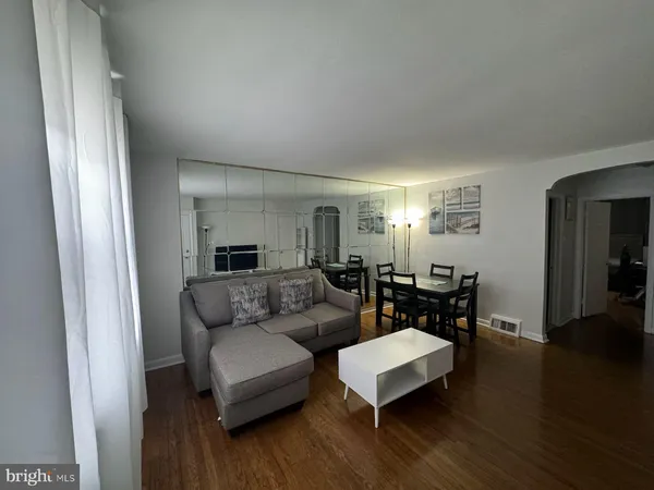 a view of a room with wooden floor