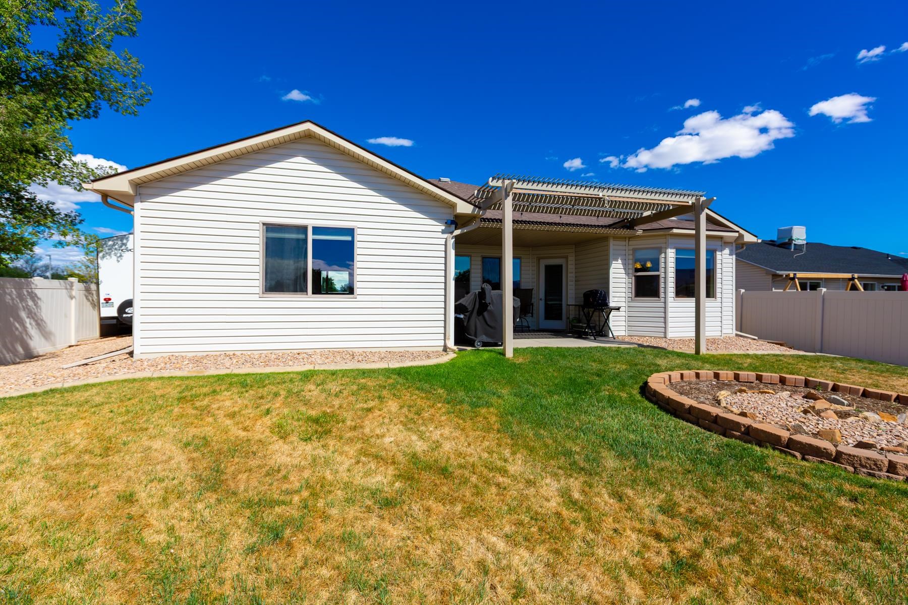 103 Red Rocks Street Fruita, CO 81521 - Photo 10 of 39 a view of a house with a backyard