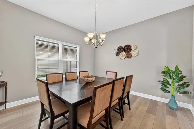 a kitchen with stainless steel appliances granite countertop a sink a stove and a wooden floors