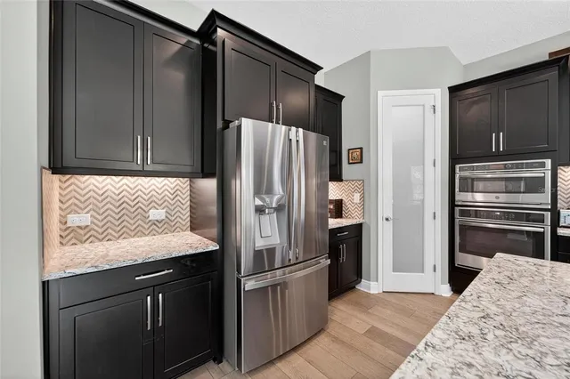 a en suite bathroom with a granite countertop sink and a mirror