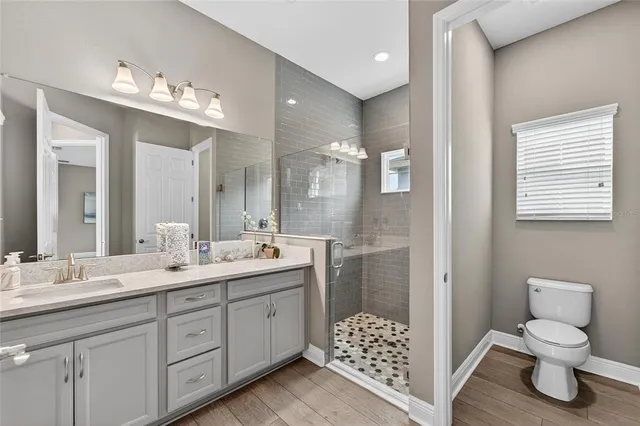 a front view of a house with a yard and potted plants