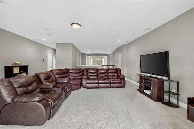 an aerial view of a house with a yard and lake view