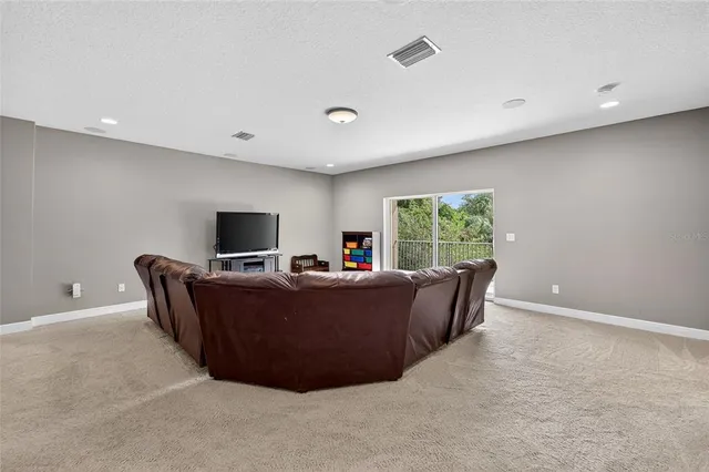 an aerial view of residential houses with outdoor space and trees