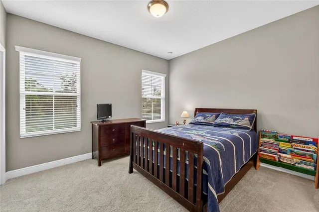 a view of a patio with a table and chairs under an umbrella