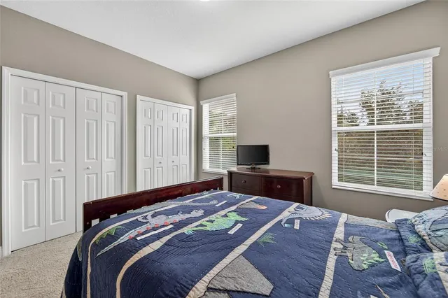 an aerial view of a house with a yard and a car park