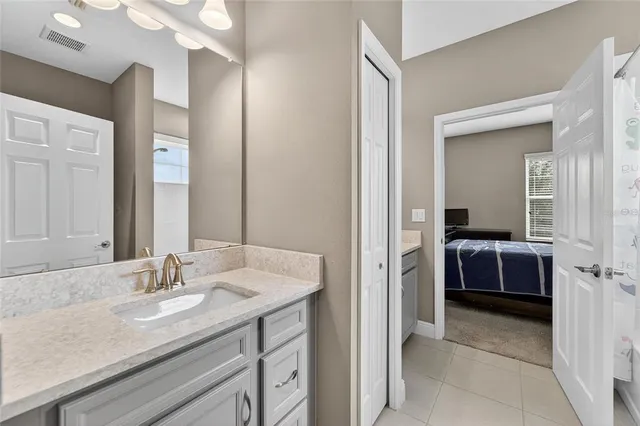 a view of a patio with a table chairs and a floor to ceiling window