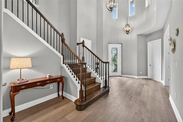 a view of a dining room with furniture wooden floor and chandelier