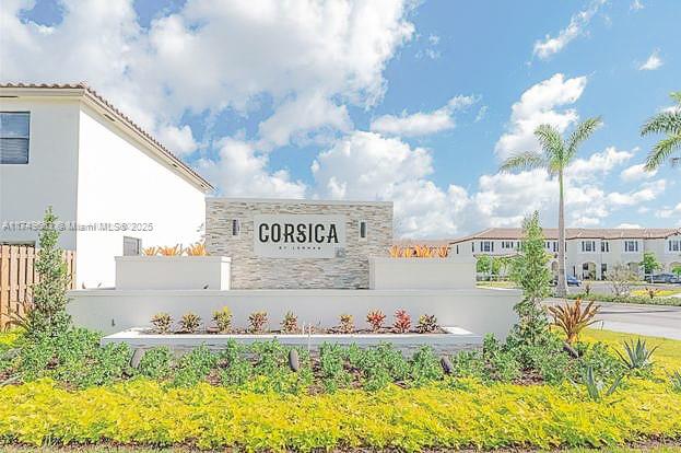 a sign that is sitting in front of flowers