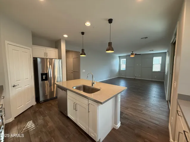 wooden floor in an empty room with a kitchen