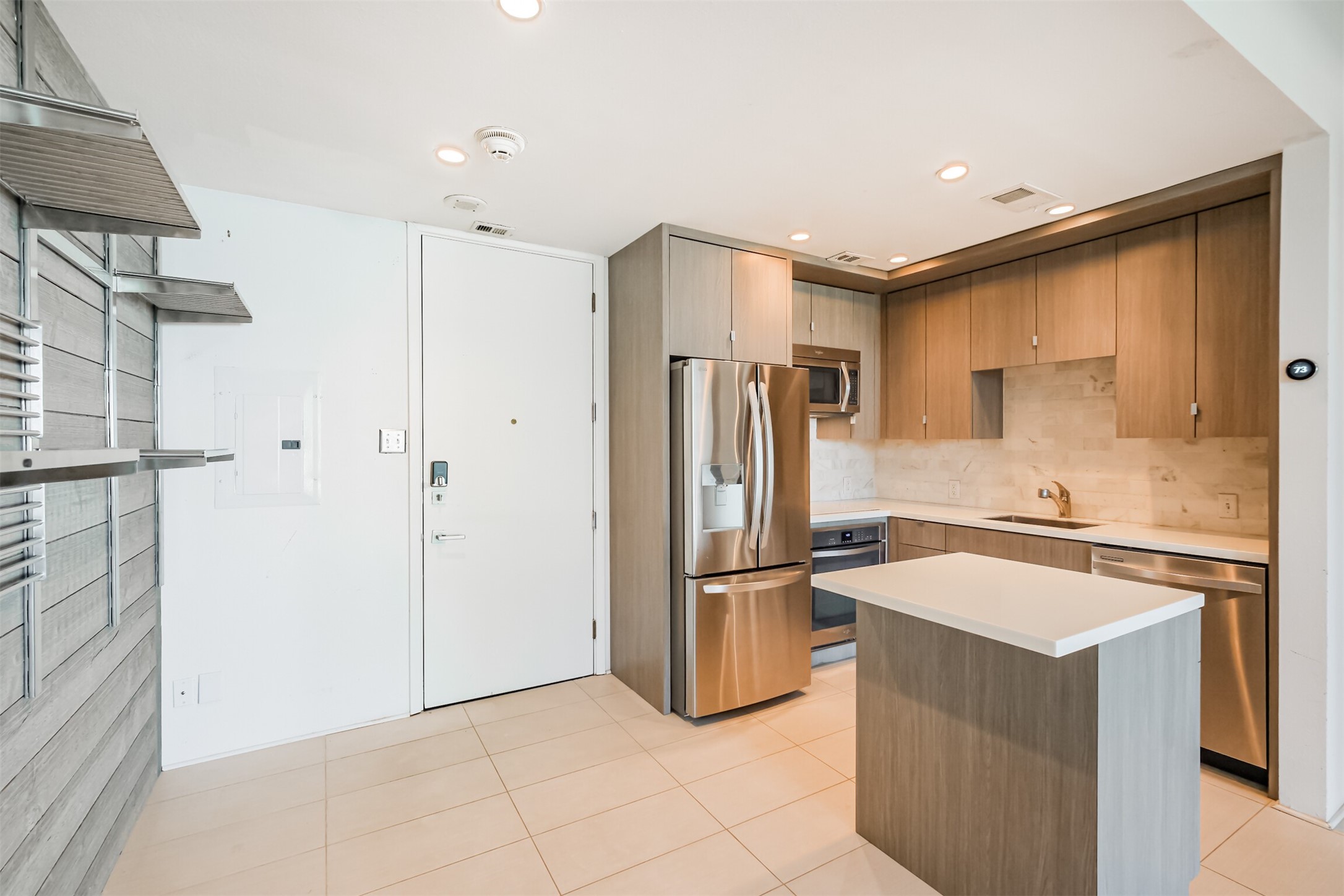 3600 Montrose Boulevard, Unit 104 Houston, TX 77006 - Photo 12 of 42 a kitchen with a refrigerator a sink and cabinets