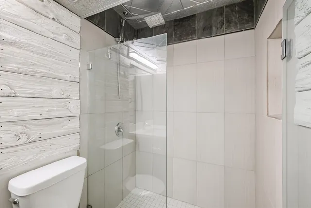 a bathroom with a toilet and shower