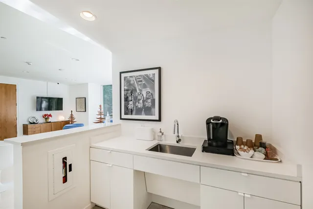 a kitchen with a sink a stove and cabinets