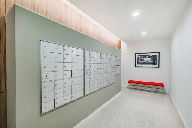 a view of a hallway with closet and wooden floor