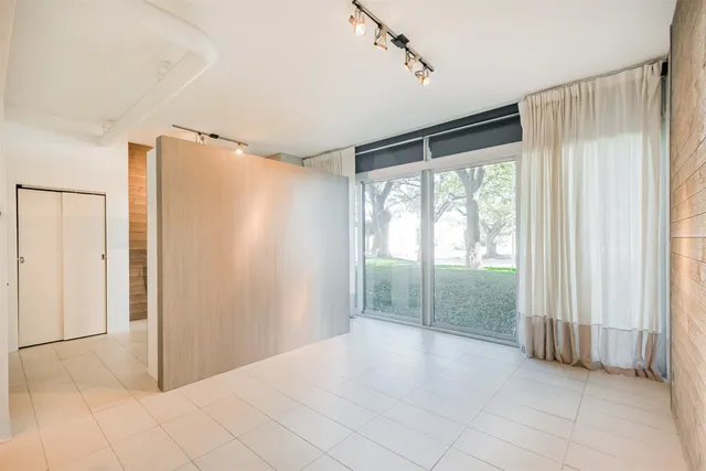 a view of room with window and a ceiling fan