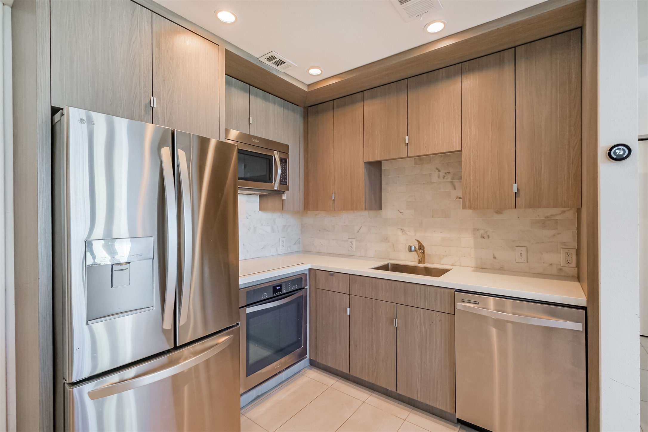 3600 Montrose Boulevard, Unit 104 Houston, TX 77006 - Photo 7 of 42 a kitchen with stainless steel appliances a refrigerator sink and microwave