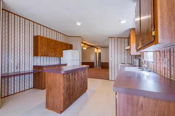 a view of a hallway with entryway wooden floor and front door