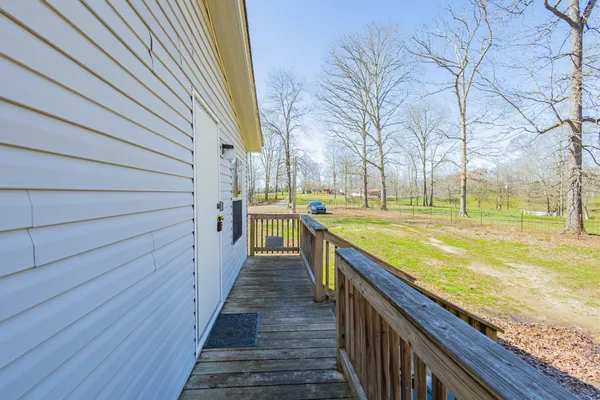 a view of a house with wooden fence