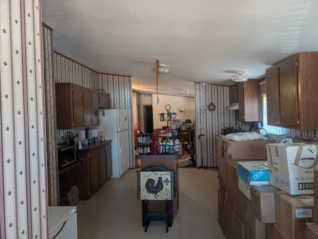 a living room with a couch and a refrigerator