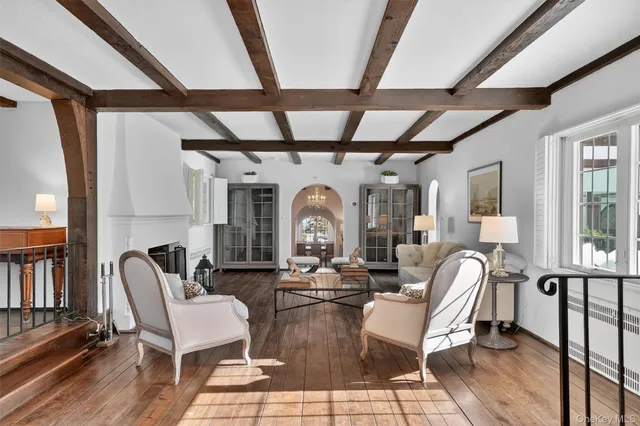 a view of a dining room with furniture large windows and wooden floor