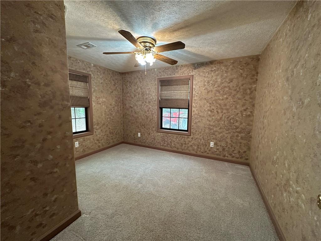 710 Spiva Road Temple, GA 30179 - Photo 27 of 31 an empty room with windows and fan