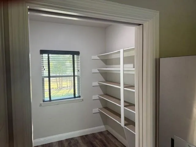 a view of a room with rack on the wall and a window