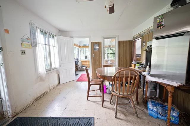 a living room with furniture a flat screen tv and a window