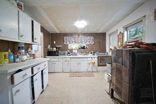 a kitchen with a refrigerator and window
