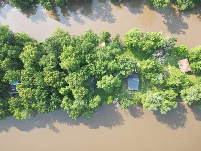 a backyard of a house with a yard and outdoor seating